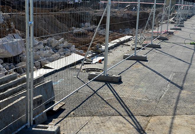 a set of temporary fence panels protecting a construction site